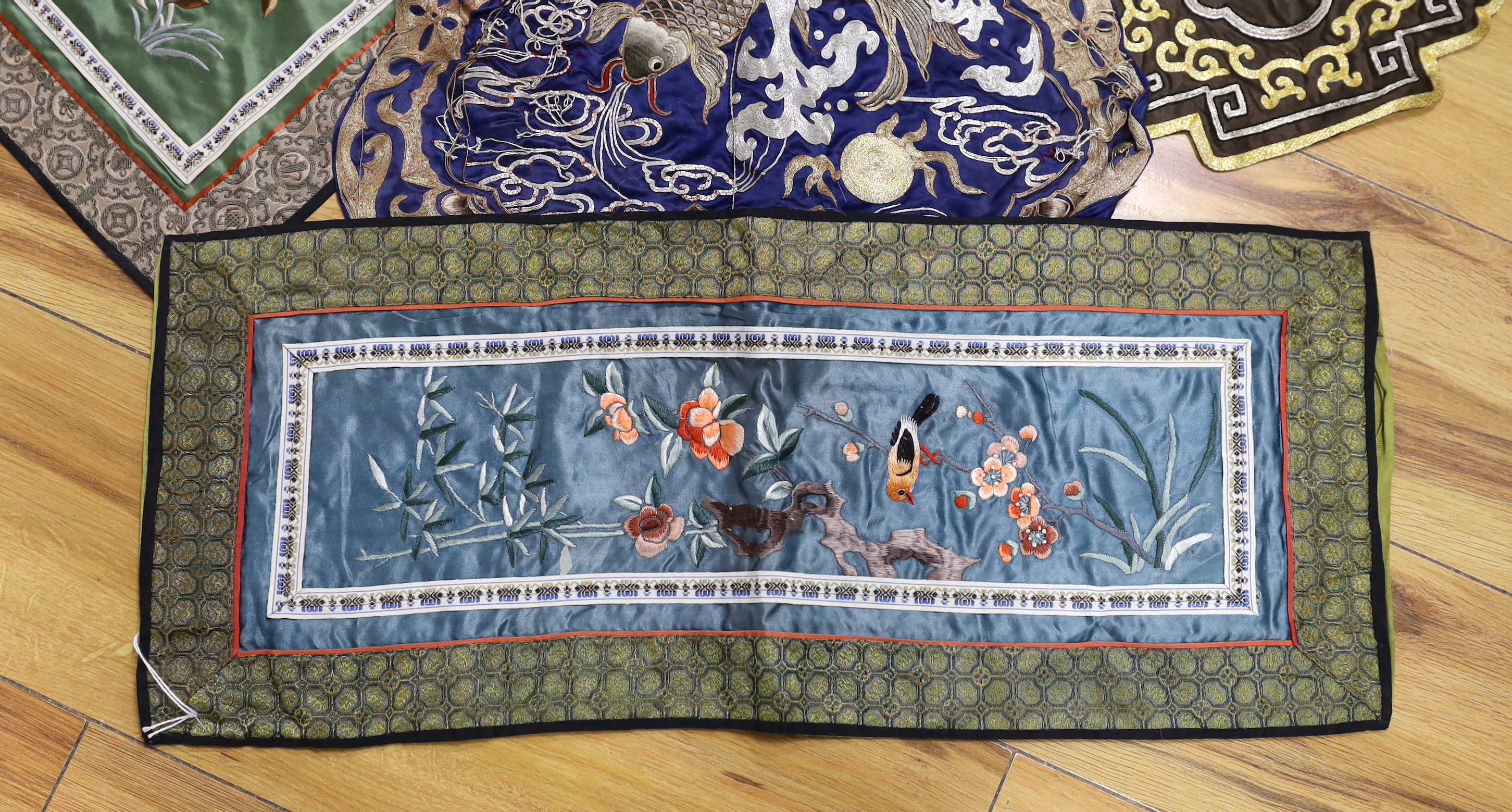 Five Chinese embroideries including one with gilt thread and one gauze example embroidered with birds